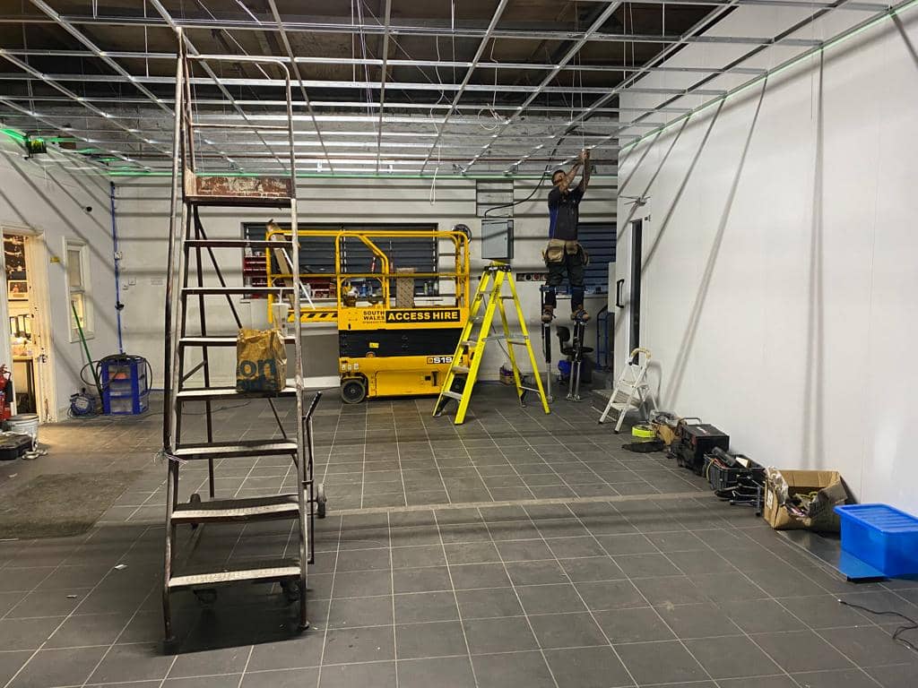 Fitting suspended ceiling at AWL new workshop refit at Plasmarl Swansea
