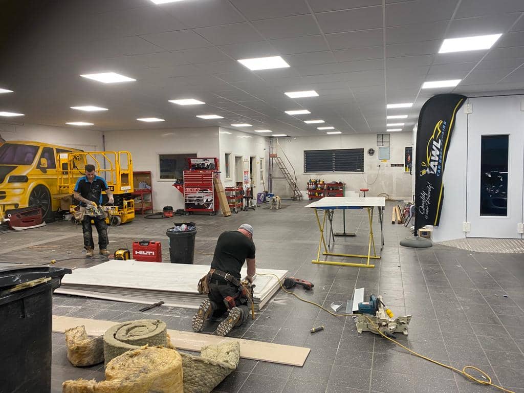 Shop Fitters at work during new workshop refit at AWL Car Body Repairs Swansea
